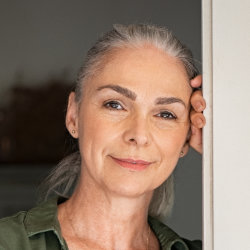 Happy mature woman's face after Kybella treatment.