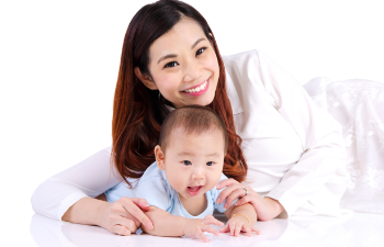 A happy Asian woman with her baby.
